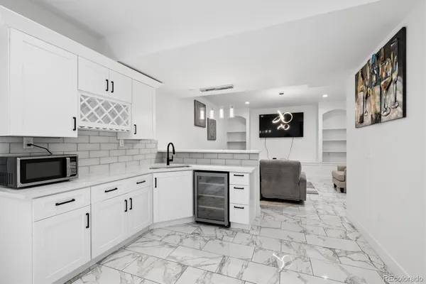 a large white kitchen with cabinets