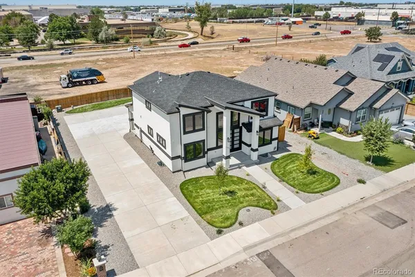 an aerial view of a house with garden space and street view