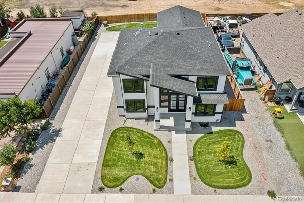 an aerial view of a house with swimming pool and furniture