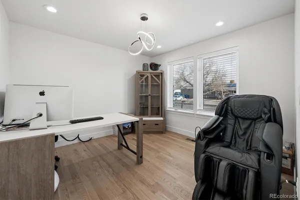 a view of a workspace with furniture and a window