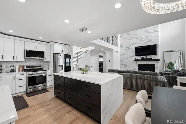a kitchen with furniture a sink and appliances