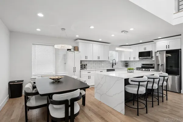 a view of kitchen with cabinets table and chairs