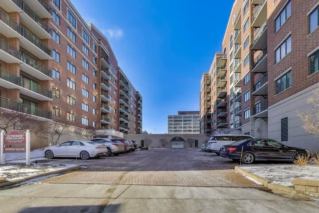 a view of a building and car parked on the street