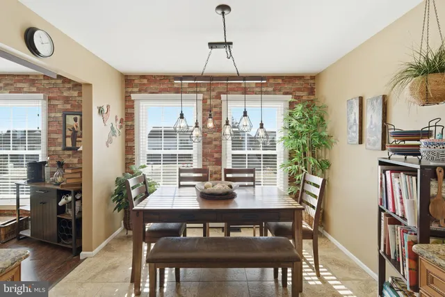 a dining room with furniture large windows and wooden floor