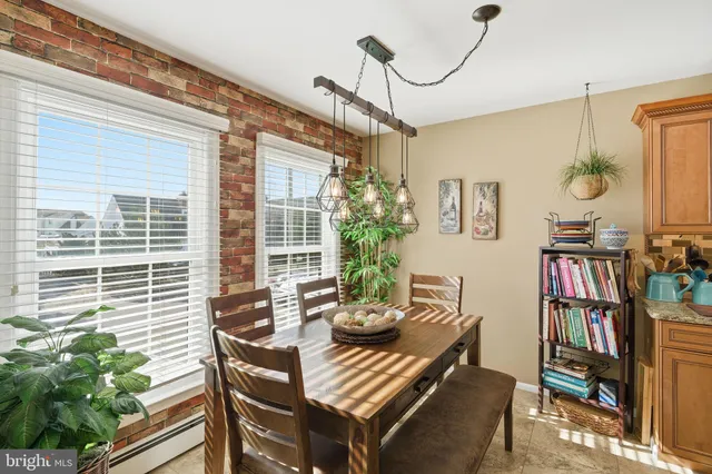 a view of a dining room with furniture and a potted plant