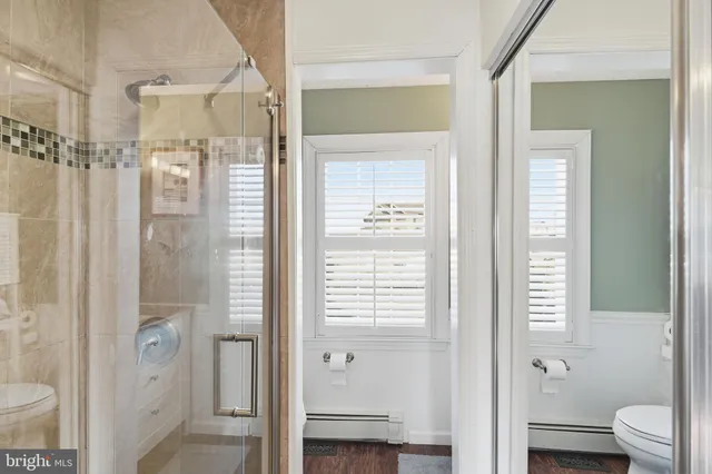 a bathroom with a shower and a toilet