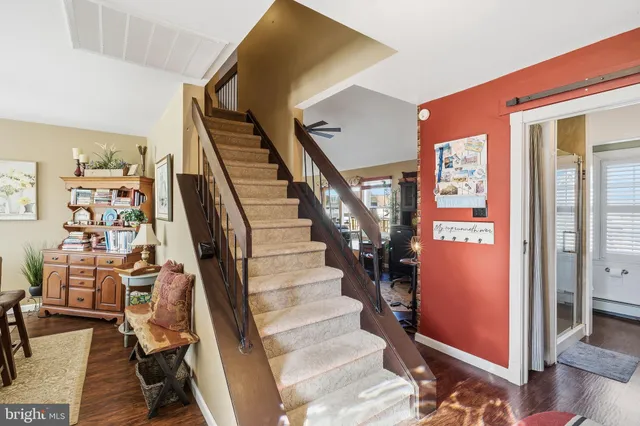 a view of entryway with furniture and wooden floor