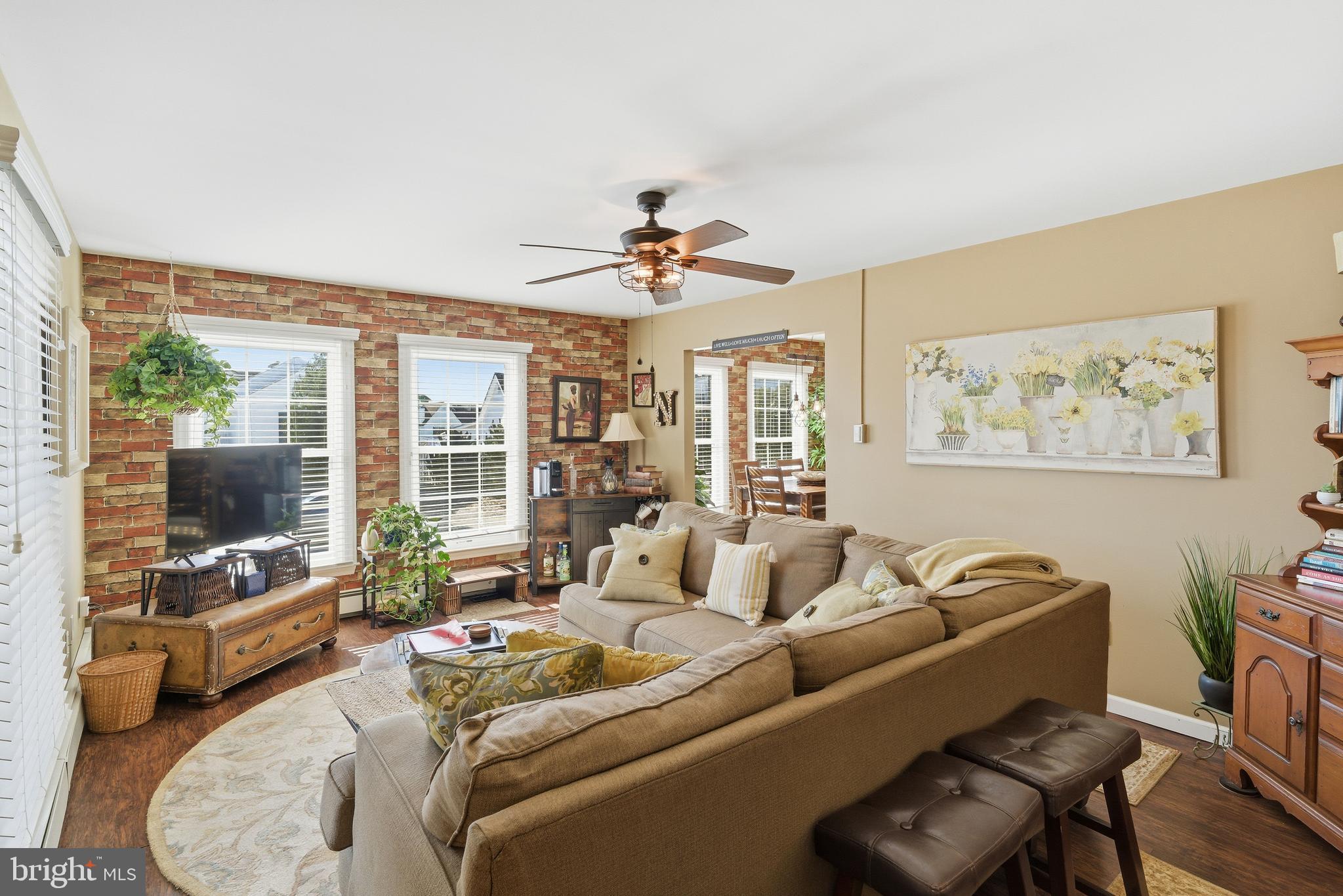179 Bernard Drive Manahawkin, NJ 08050 - Photo 9 of 35 a living room with furniture a flat screen tv and a large window