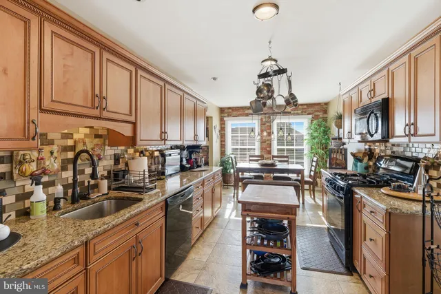 a kitchen with stainless steel appliances a stove sink and cabinets