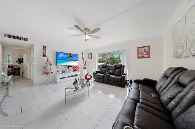a bed room with couch a ceiling fan and a couch