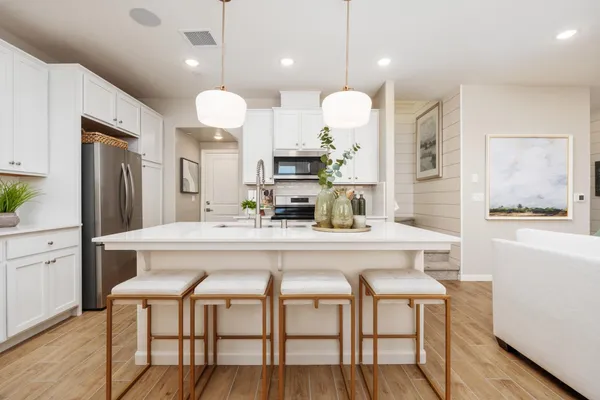 a large kitchen with a table and chairs in it