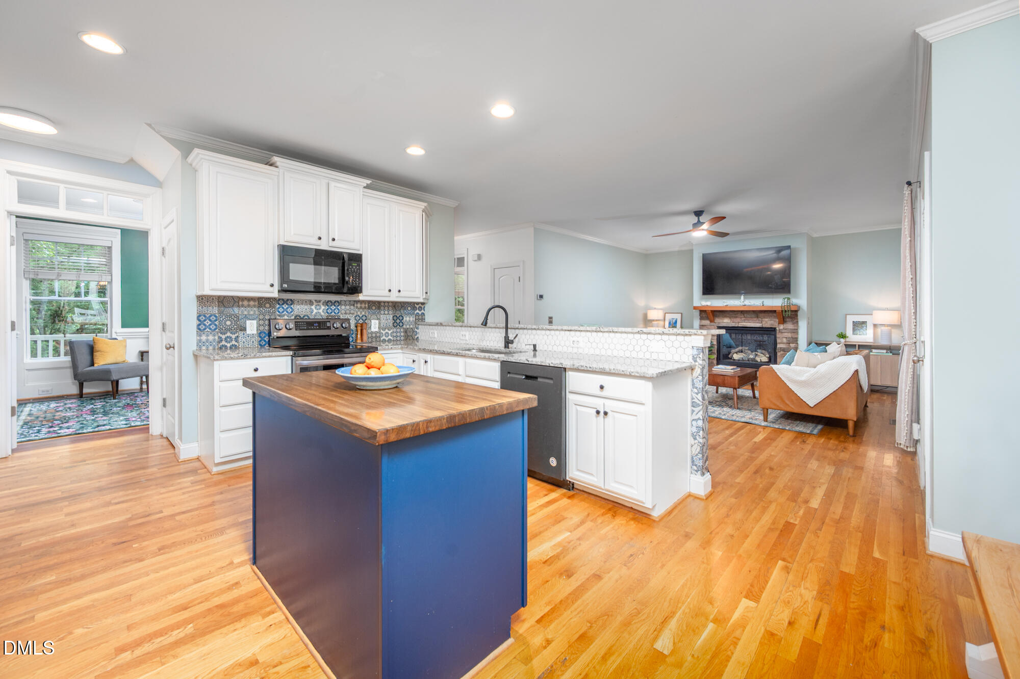 726 Ruth Circle Fuquay-Varina, NC 27526 - Photo 18 of 61 a kitchen with kitchen island a sink dishwasher stove and white cabinets with wooden floor