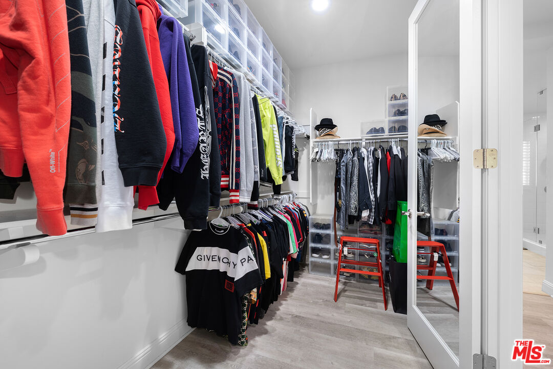 20234 Jubilee Way Porter Ranch, CA 91326 - Photo 21 of 30 a view of walk in closet with clothes and shoes