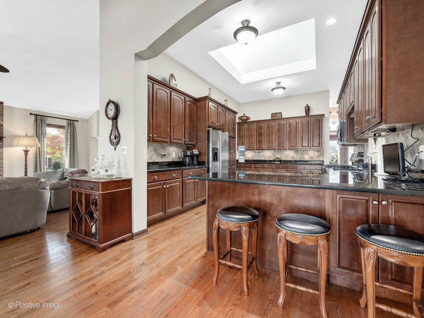 1306 Chauser Lane Woodridge, IL 60517 - Photo 13 of 40 a kitchen with stainless steel appliances granite countertop a table chairs and a refrigerator