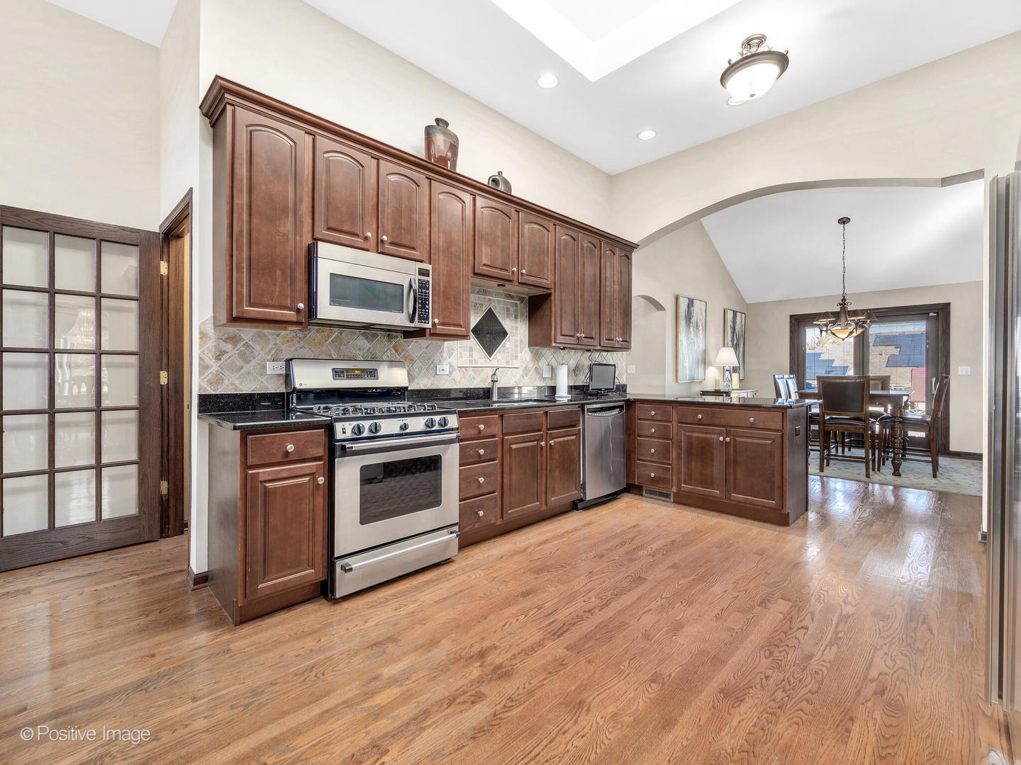 1306 Chauser Lane Woodridge, IL 60517 - Photo 15 of 40 a kitchen with a stove top oven and a refrigerator