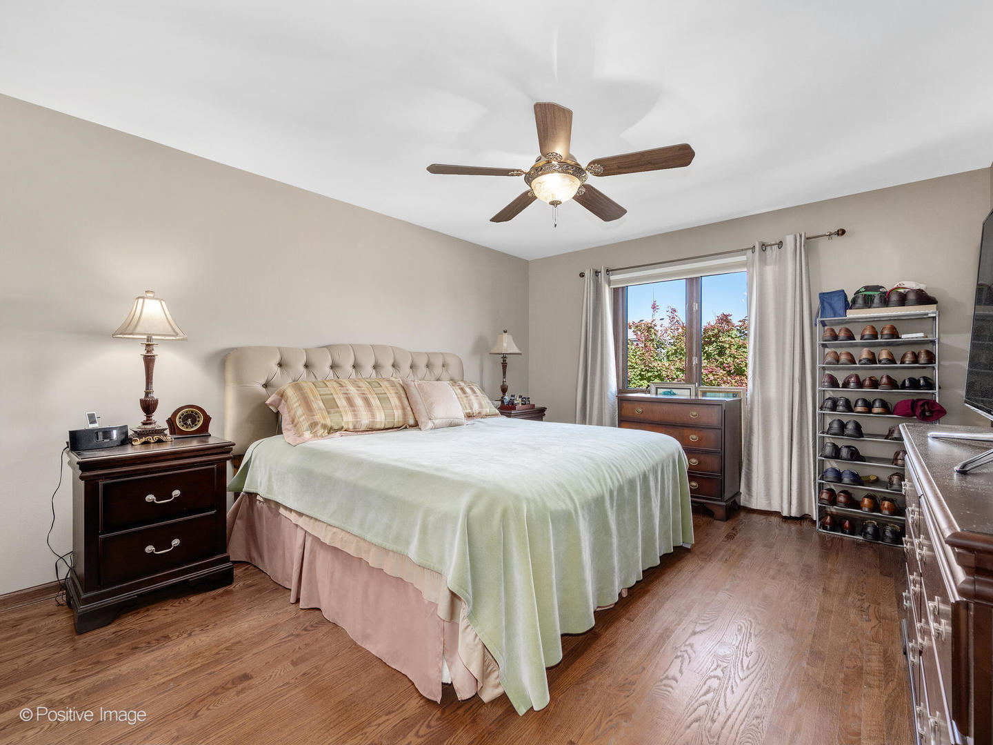 1306 Chauser Lane Woodridge, IL 60517 - Photo 27 of 40 a bedroom with a bed and a flat tv screen on dresser