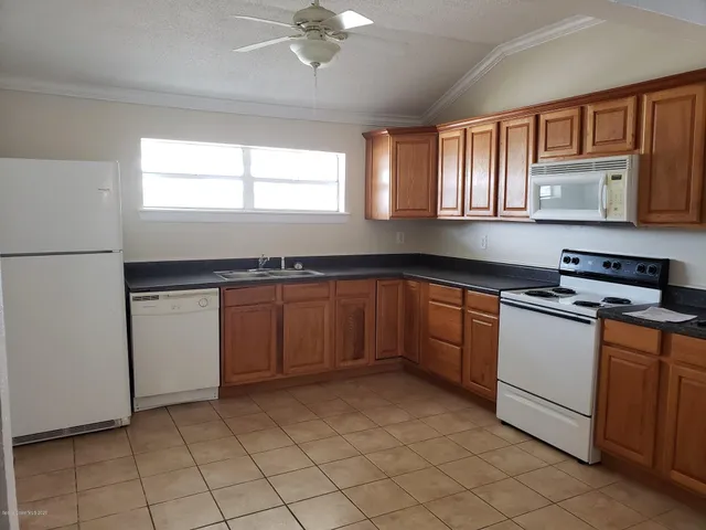 a view of empty room with window and fan