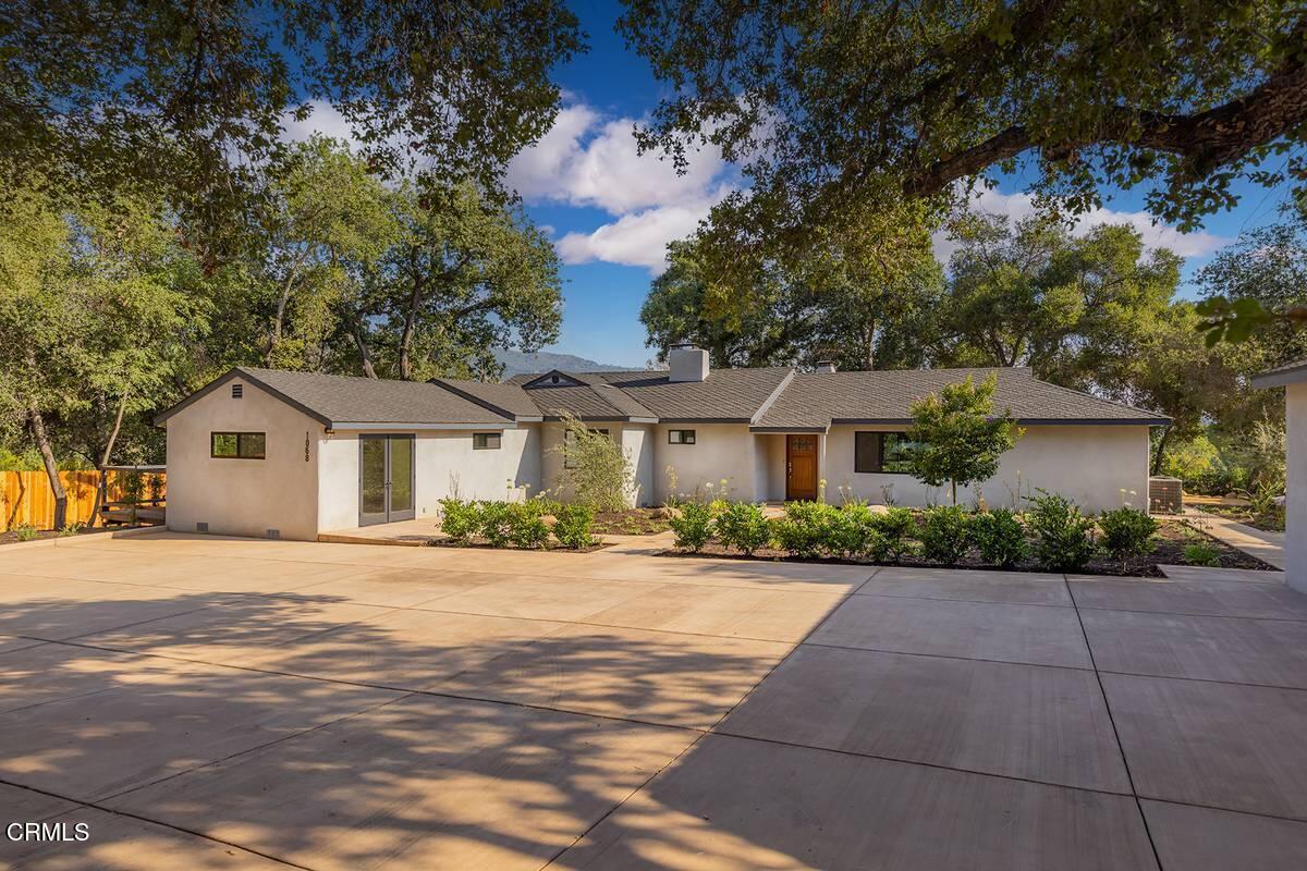 a front view of a house with a yard and a garage