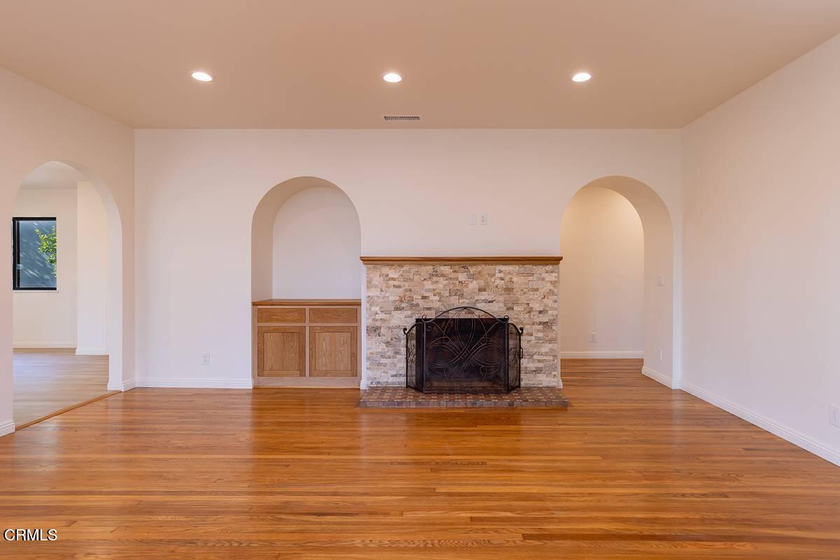 1068 Cuyama Road Ojai, CA 93023 - Photo 12 of 23 a view of an empty room with wooden floor and a fireplace