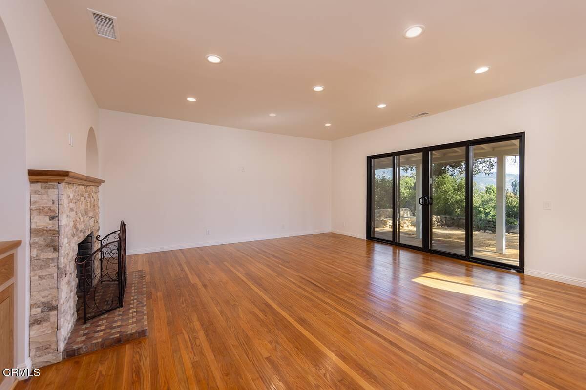 1068 Cuyama Road Ojai, CA 93023 - Photo 4 of 23 a view of a livingroom with wooden floor and a fireplace