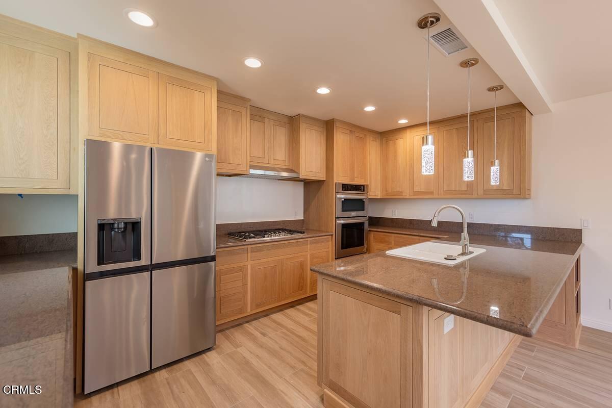 1068 Cuyama Road Ojai, CA 93023 - Photo 7 of 23 a kitchen with stainless steel appliances granite countertop a refrigerator a sink dishwasher a stove with wooden floors