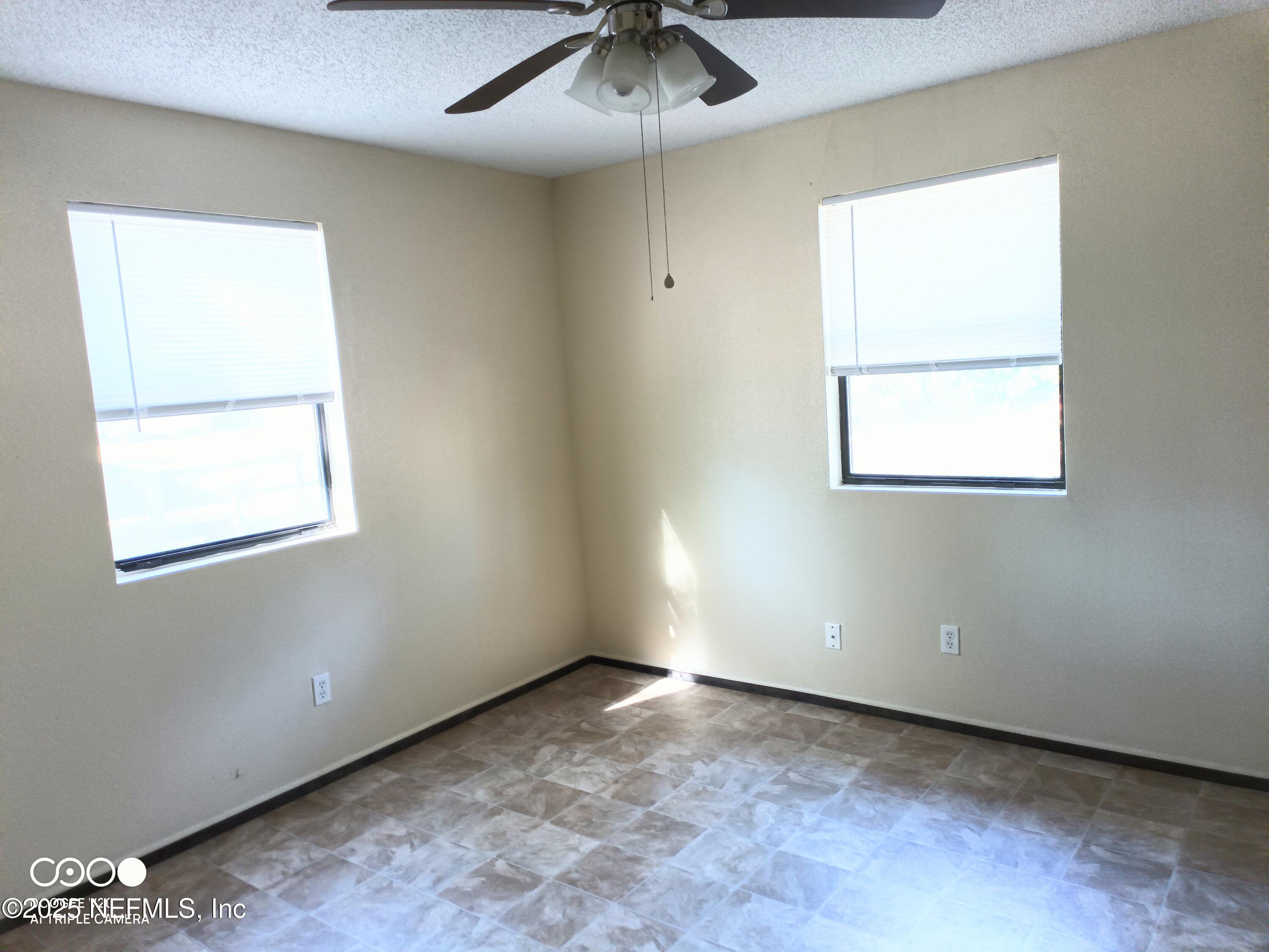 13926 Sanderson Circle Sanderson, FL 32087 - Photo 2 of 12 an empty room with a window and a fan