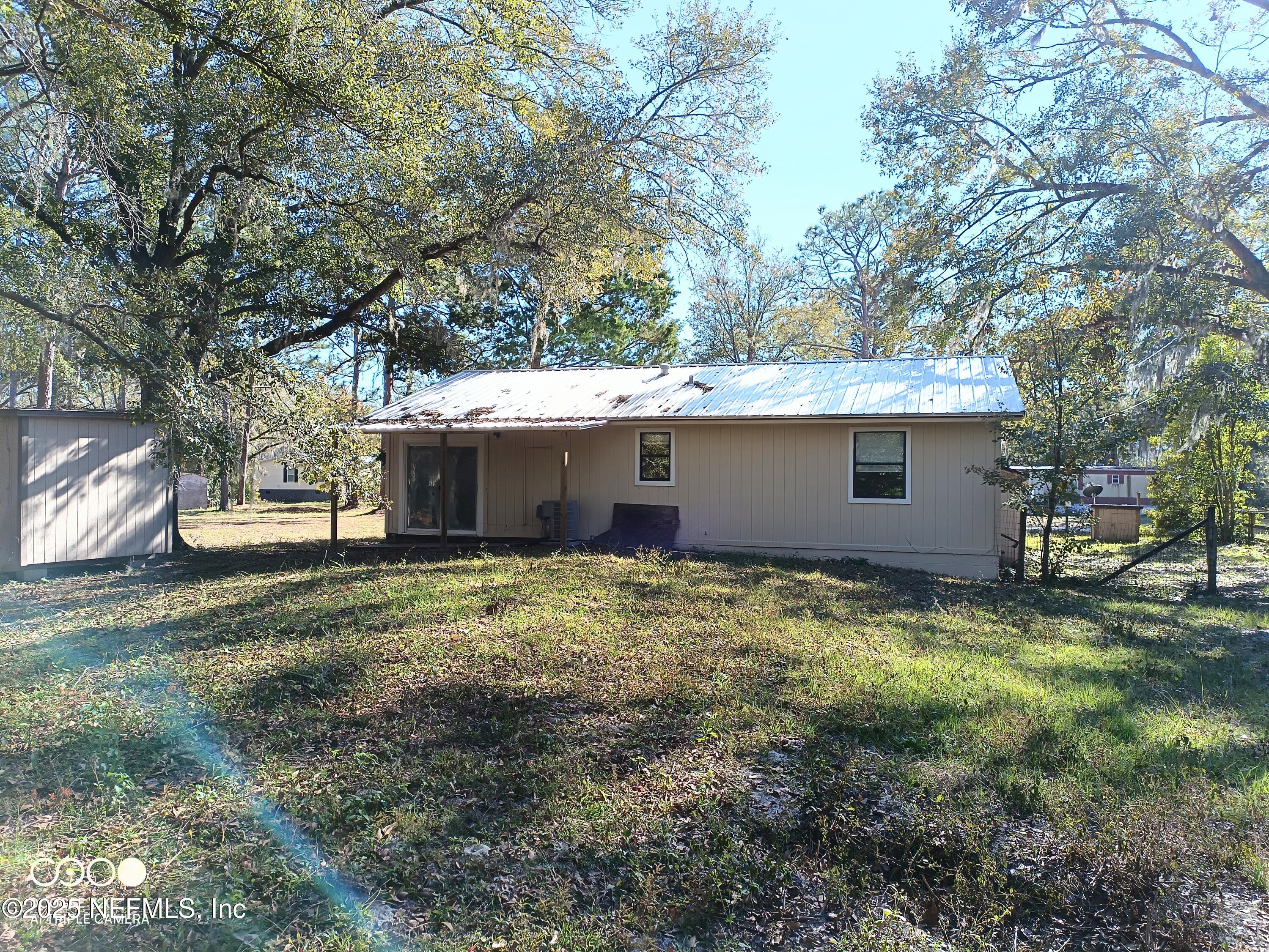 13926 Sanderson Circle Sanderson, FL 32087 - Photo 9 of 12 a view of a house with a yard