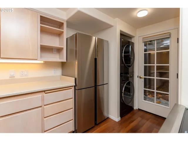 a kitchen with refrigerator and cabinets