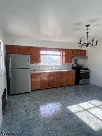 a kitchen with cabinets and a refrigerator