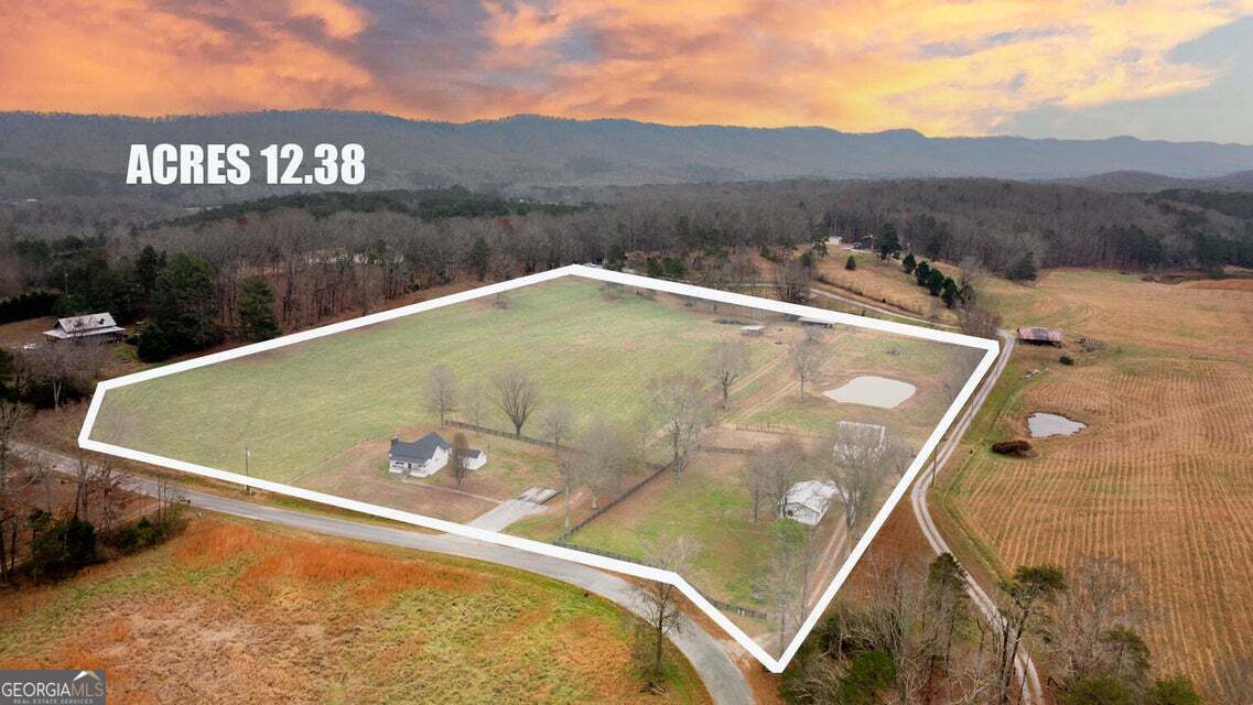 a view of a swimming pool with a yard and mountain view in back