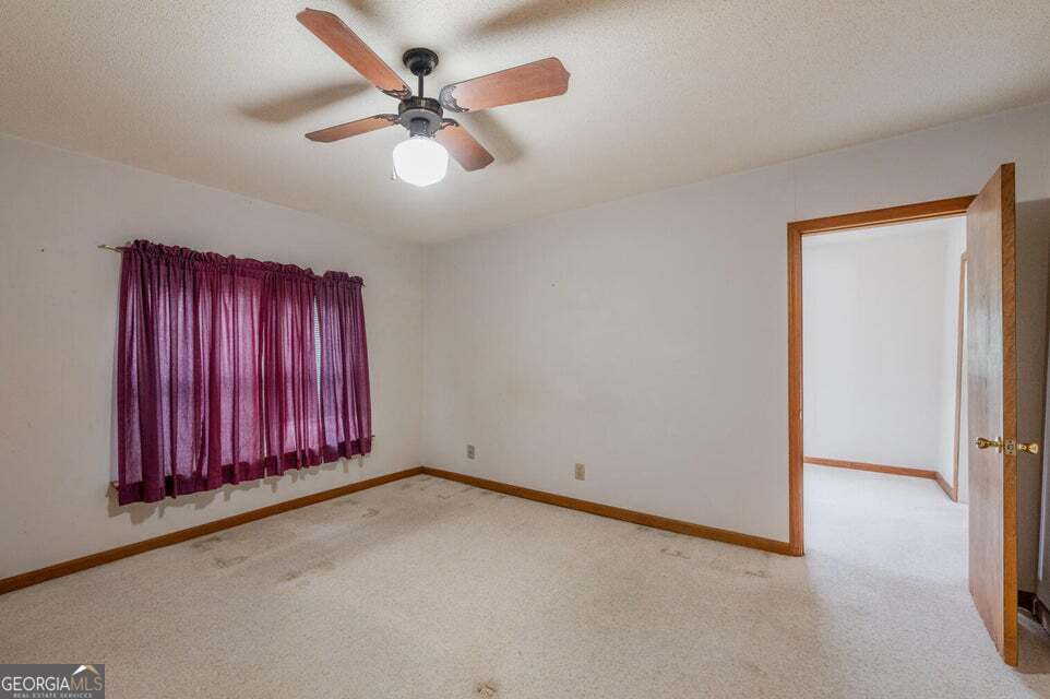 626 Greenbush Road LaFayette, GA 30728 - Photo 17 of 53 an empty room with windows and fan