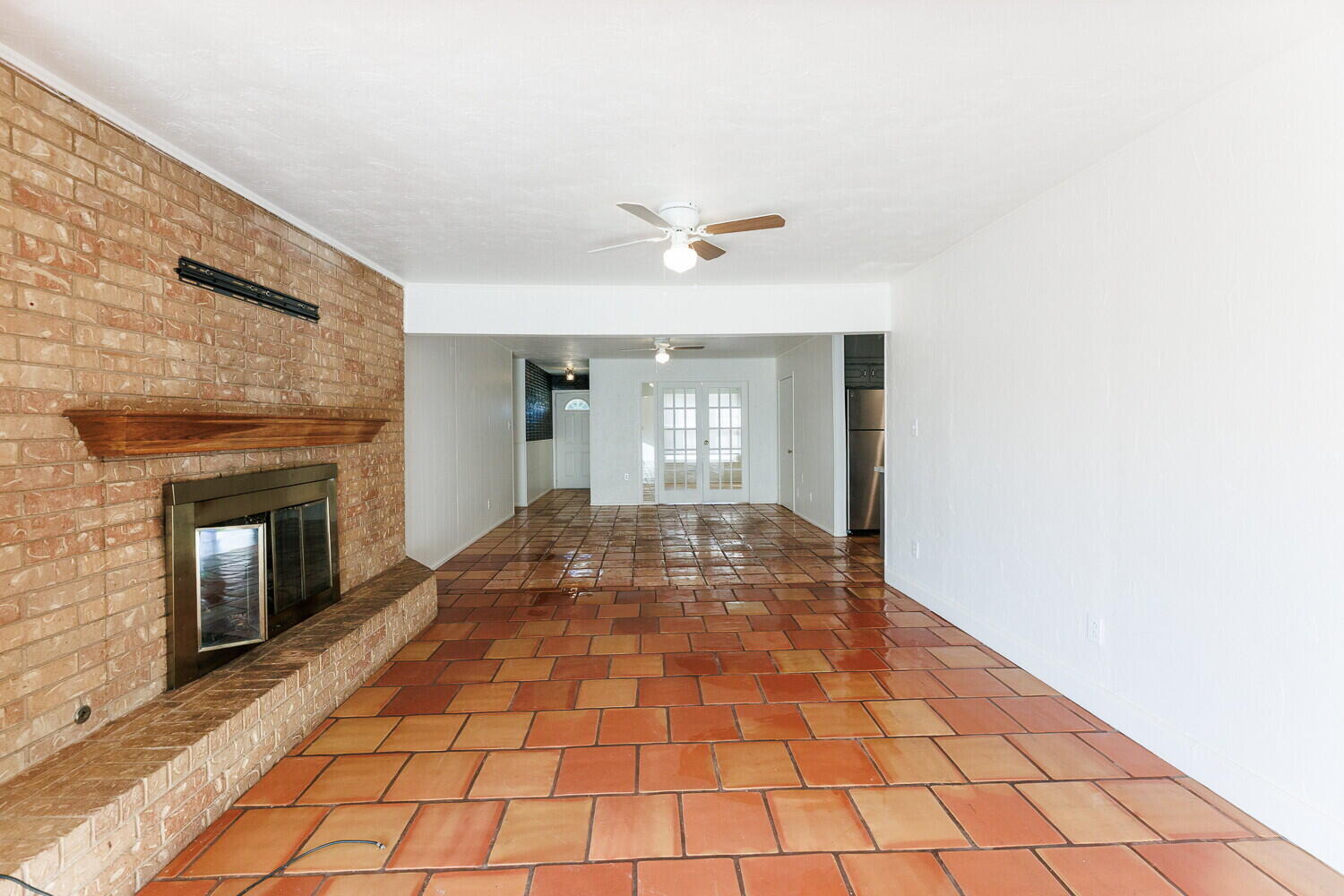 4714 46th Street Lubbock, TX 79414 - Photo 15 of 57 a view of empty room with wooden floor and fireplace
