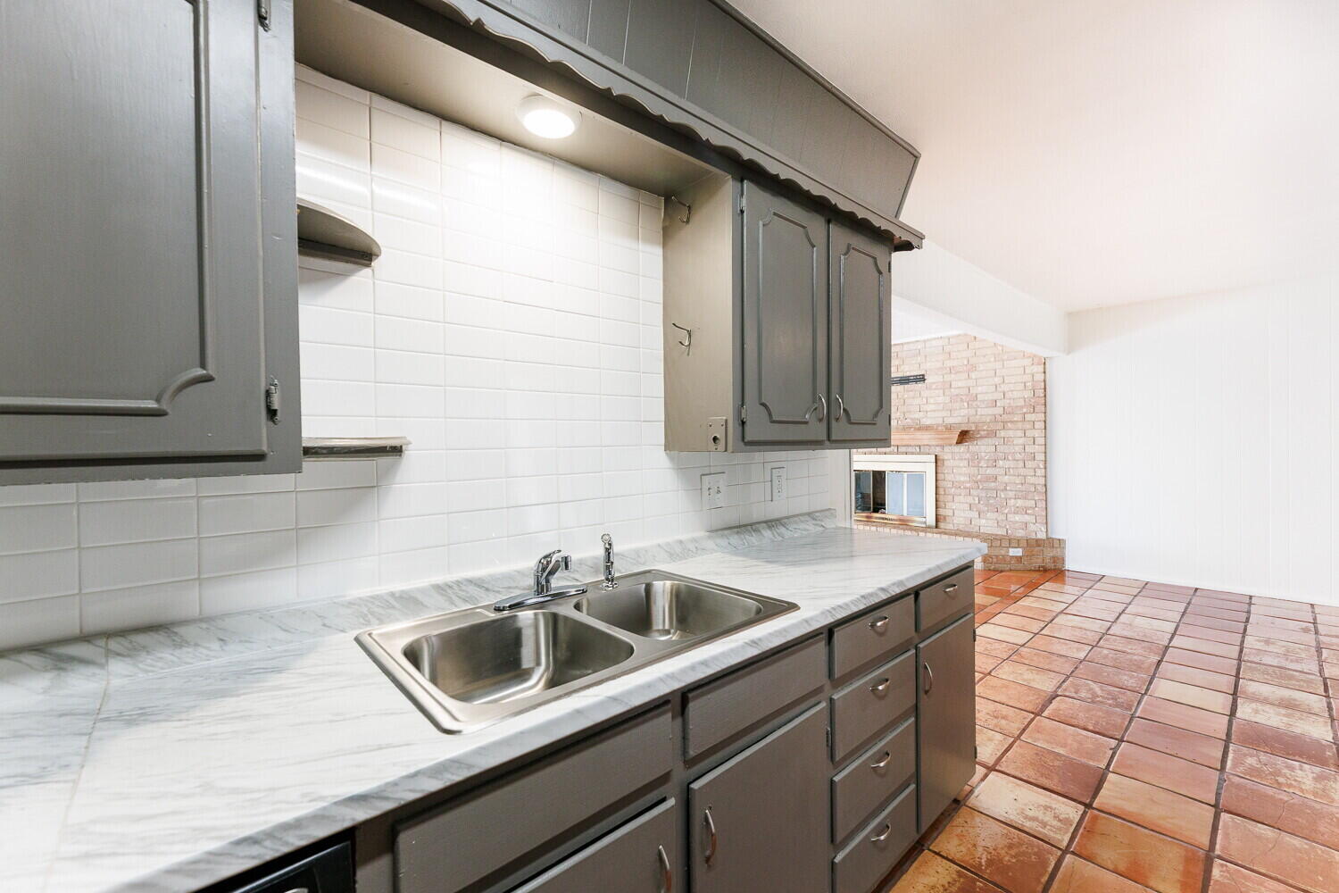 4714 46th Street Lubbock, TX 79414 - Photo 21 of 57 a kitchen with a sink and cabinets