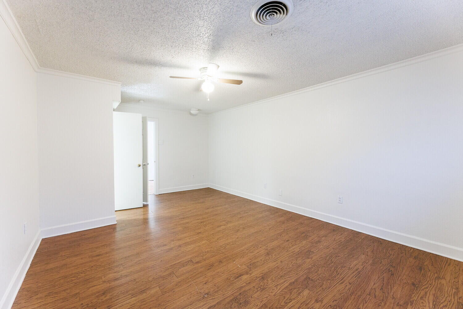4714 46th Street Lubbock, TX 79414 - Photo 26 of 57 an empty room with wooden floor chandelier fan and windows