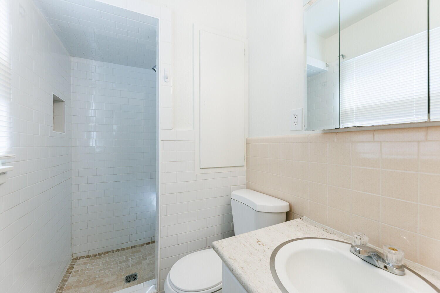 4714 46th Street Lubbock, TX 79414 - Photo 37 of 57 a white toilet sitting next to a bathroom sink and a shower