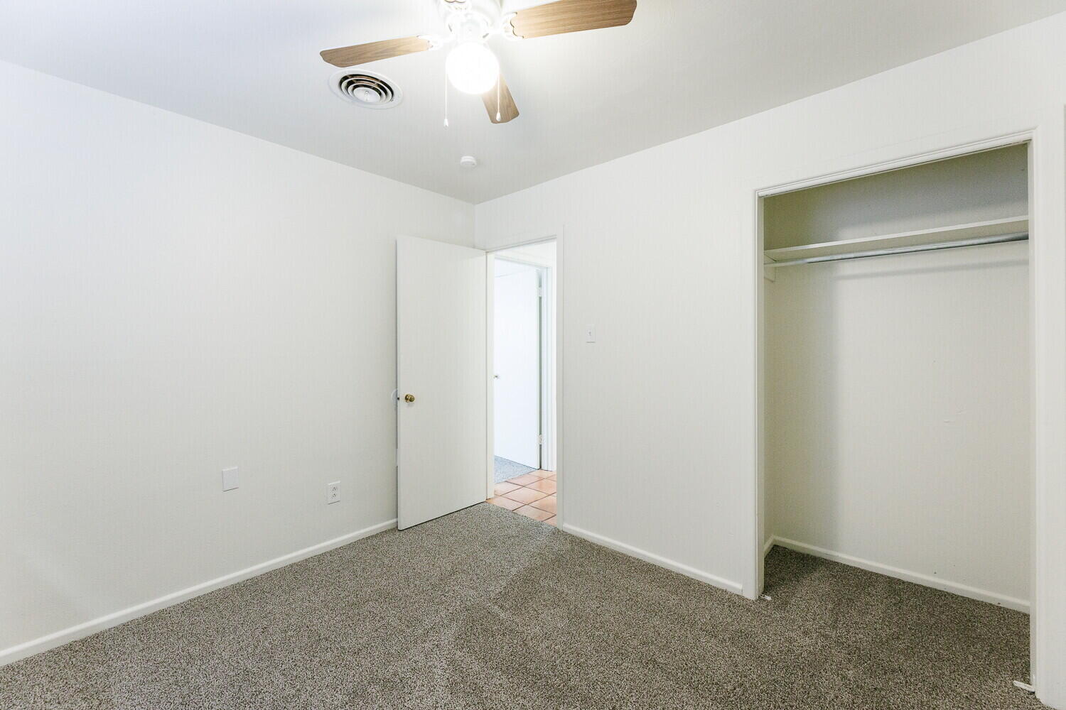 4714 46th Street Lubbock, TX 79414 - Photo 40 of 57 an empty room with a chandelier fan and windows