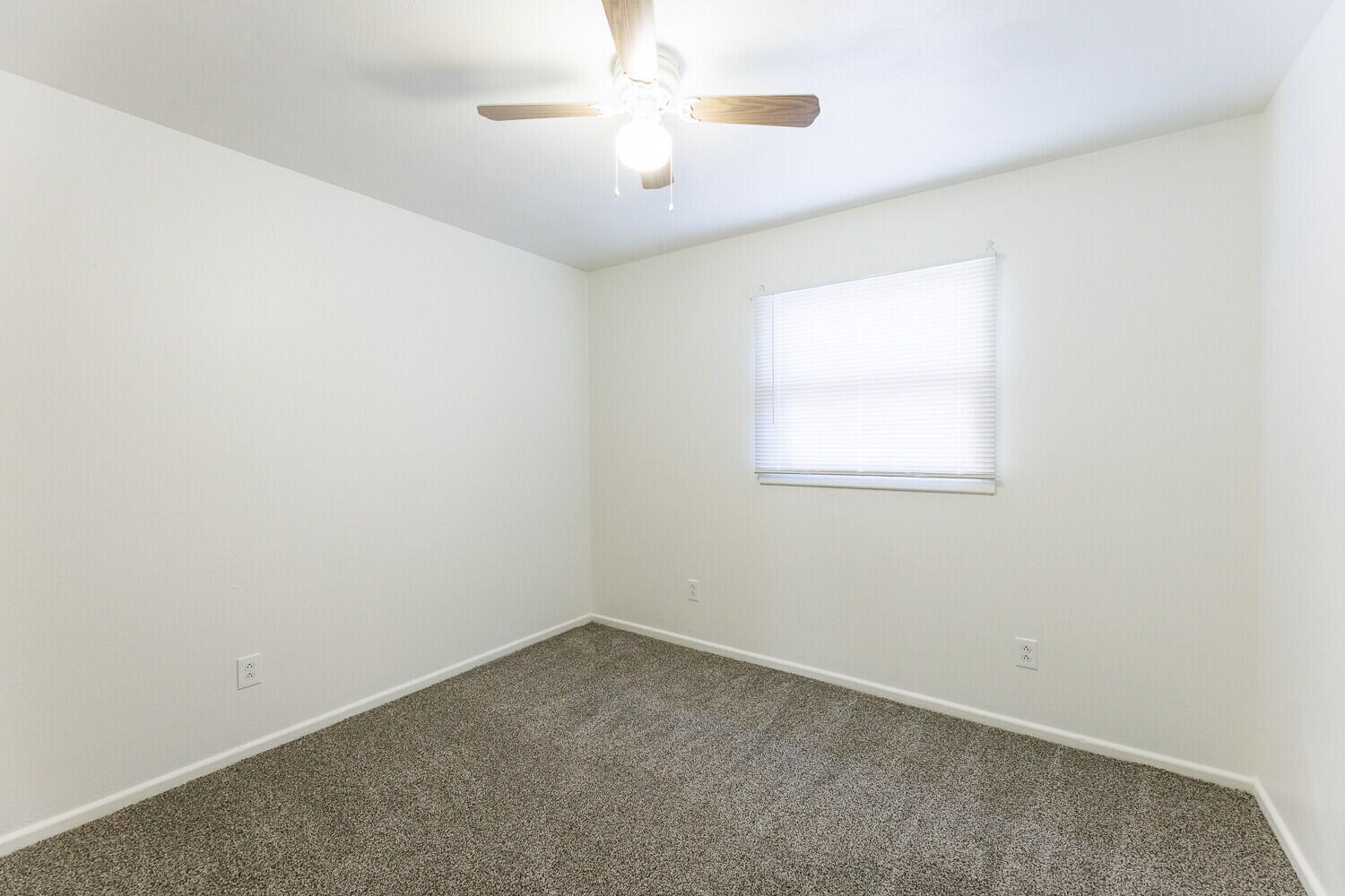 4714 46th Street Lubbock, TX 79414 - Photo 41 of 57 an empty room with a window and a fan
