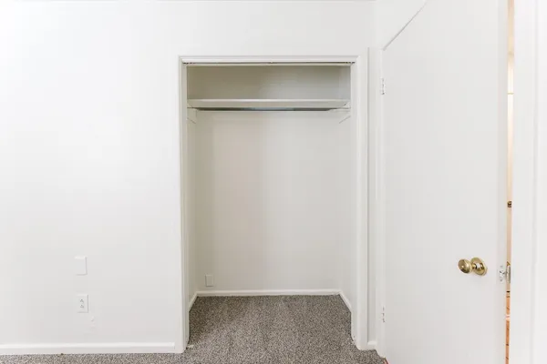 a white toilet sitting next to a window