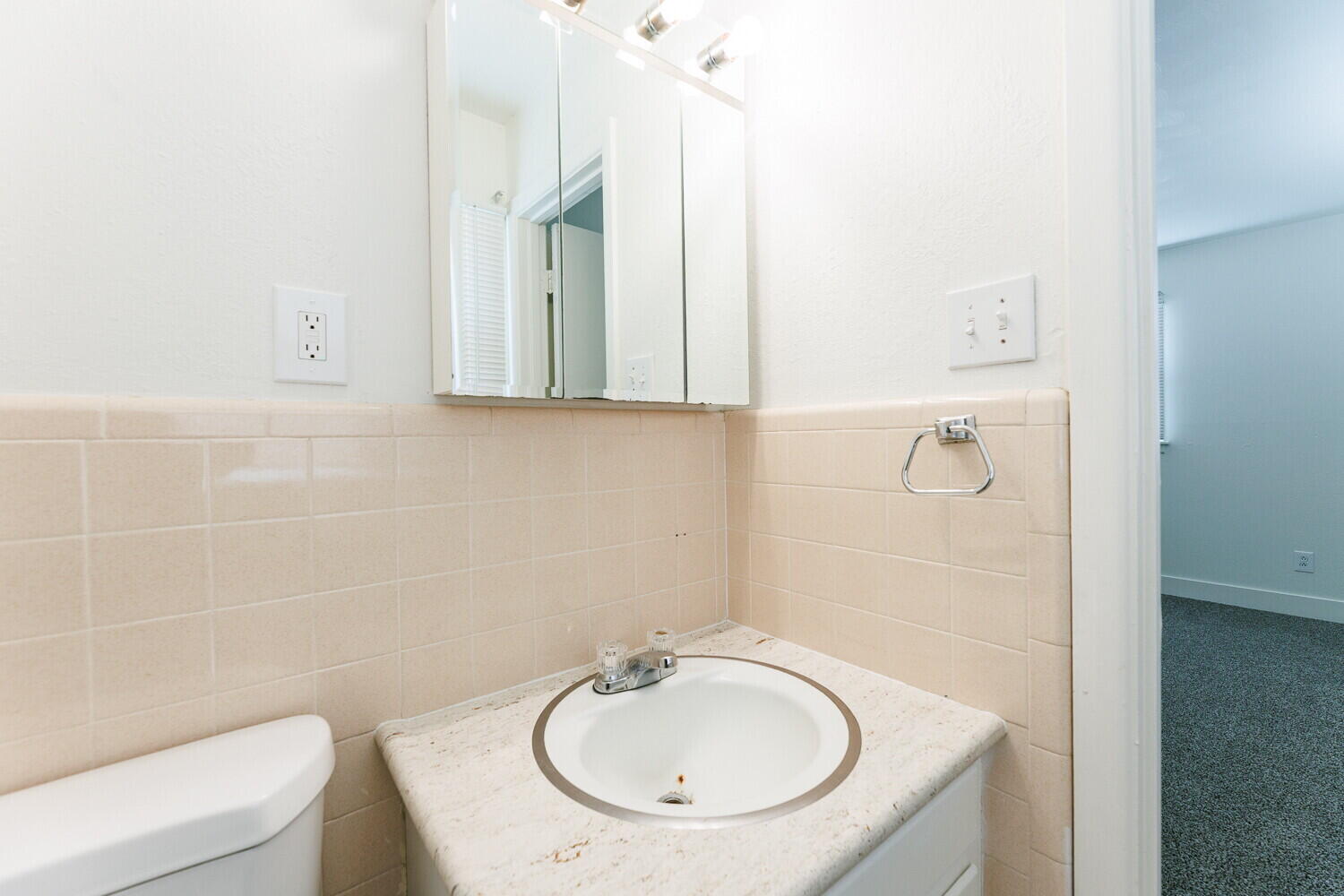 4714 46th Street Lubbock, TX 79414 - Photo 48 of 57 a bathroom with a sink a toilet and mirror
