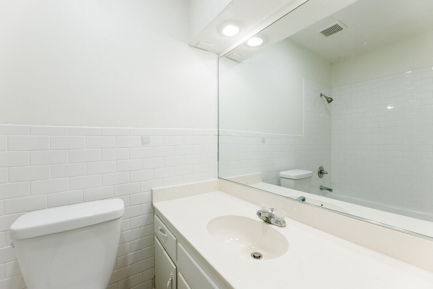 4714 46th Street Lubbock, TX 79414 - Photo 50 of 57 a bathroom with a sink a toilet and a mirror