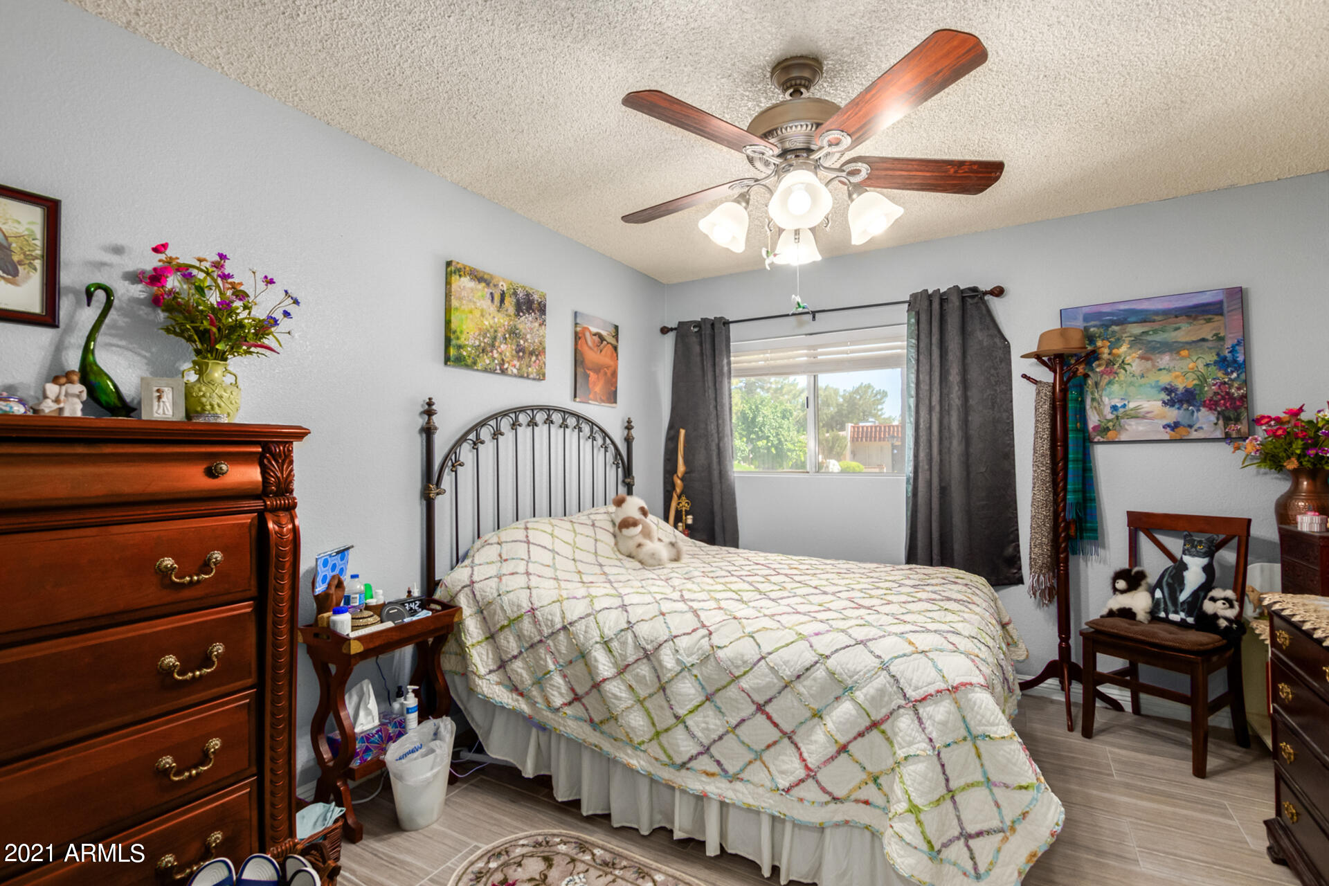 625 South Power Road, Unit 351 Mesa, AZ 85206 - Photo 20 of 31 a bedroom with a bed and a chandelier