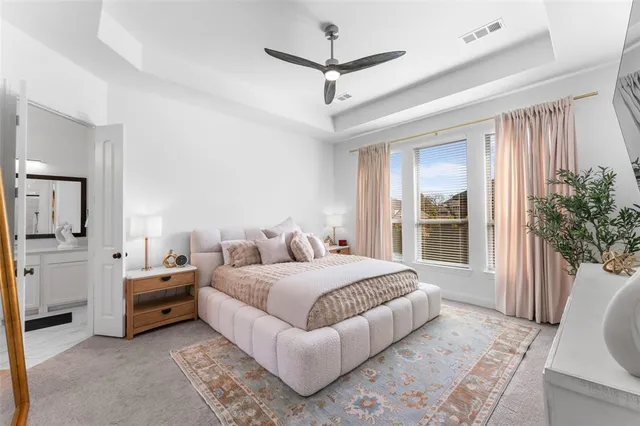 a bedroom with a large bed couch and a window