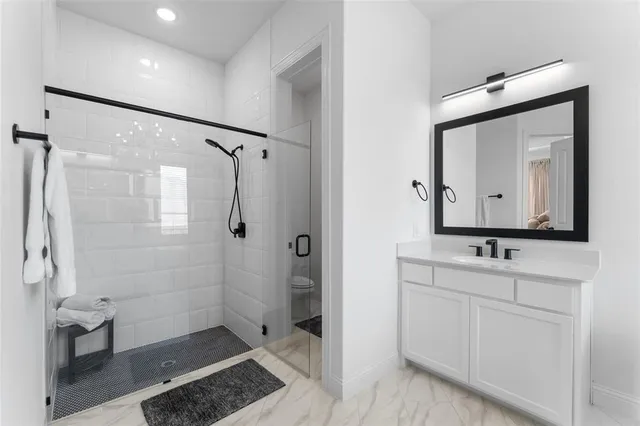 a bathroom with a double vanity sink mirror and shower