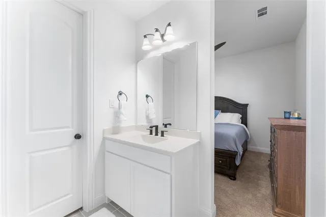 a en suite bathroom with a sink and a mirror