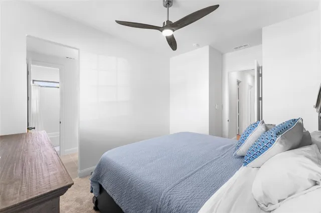 a bedroom with a bed and a dresser