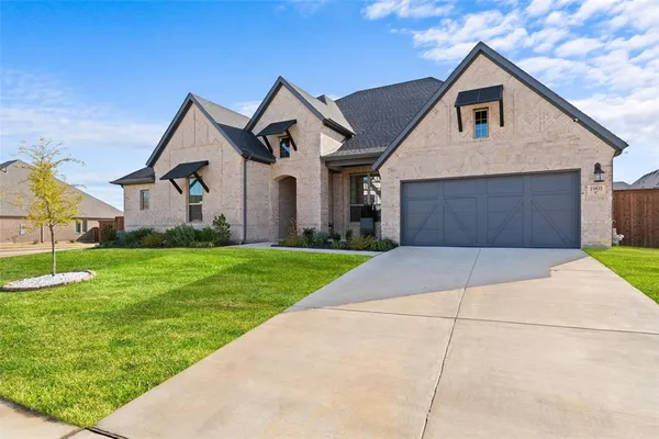 a front view of house with yard and green space