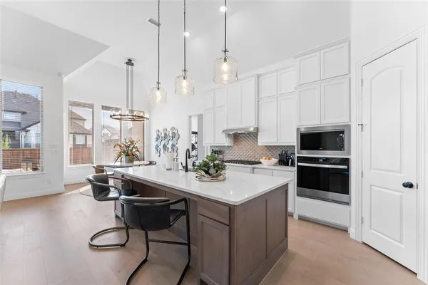 a kitchen with a sink a stove a microwave and cabinets