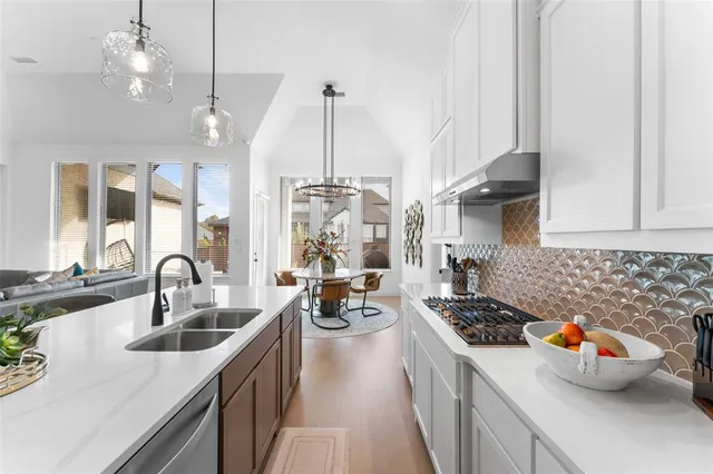 a kitchen with a sink stove and cabinets