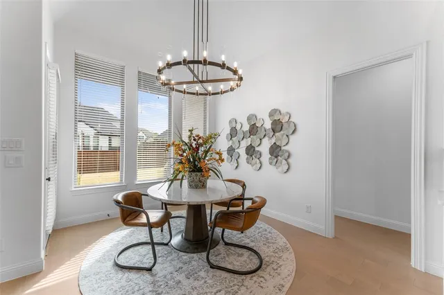 a dining room with furniture a chandelier and window