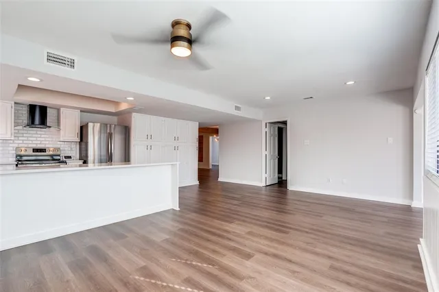 a view of a kitchen with a sink and wooden floor